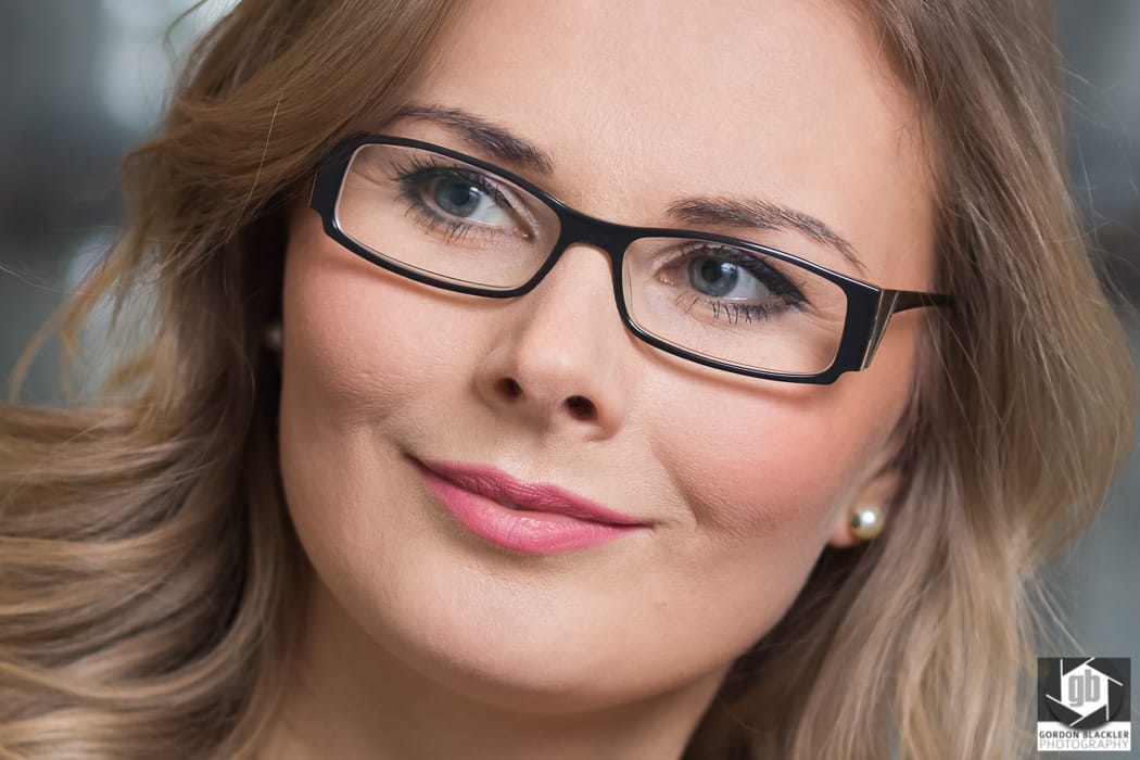 business portrait of smiling woman wearing glasses
