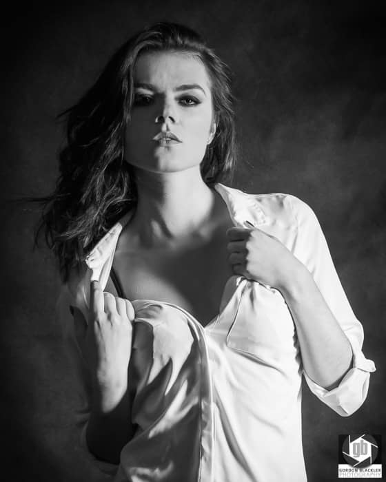 moody black & white photo of a beautiful brunette in a white shirt