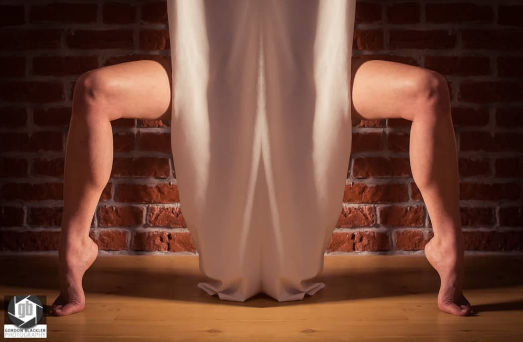 conceptual photo of legs on tiptoe hiding behind curtain